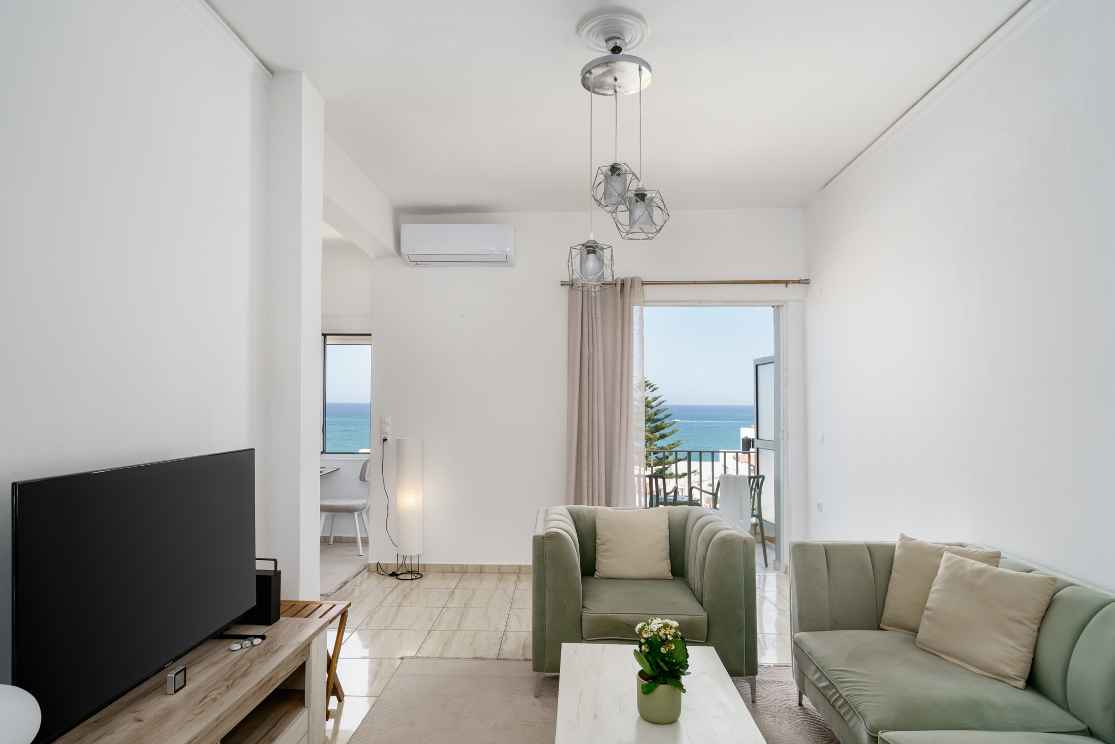 Bright living room at Costa Apartment with the sea beyond