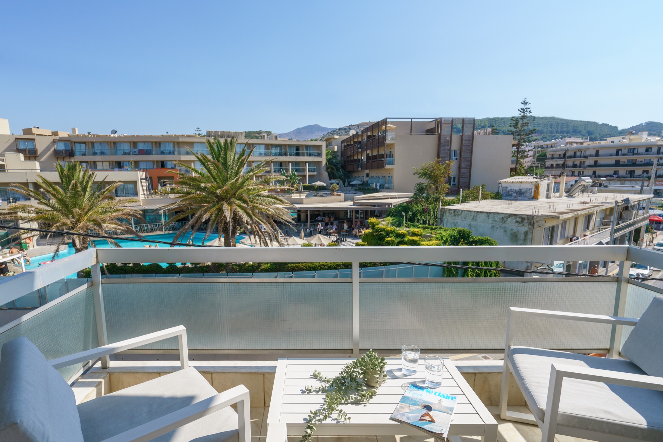 Furnished balcony with palms and city views